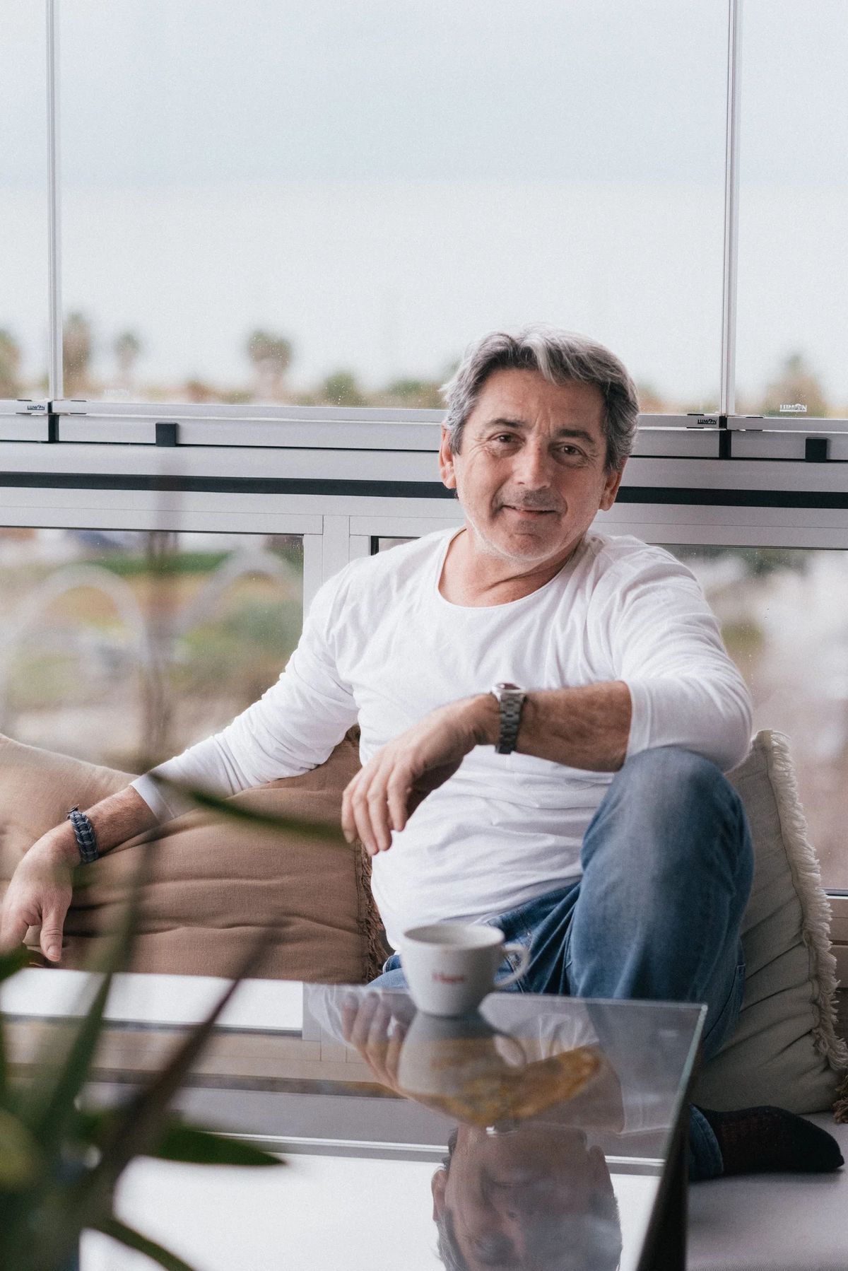 Carlos Santaolalla seated with a Hagen coffee